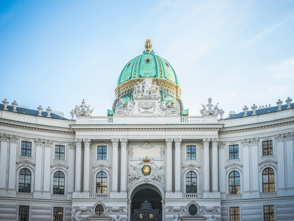 a large white building with a green dome