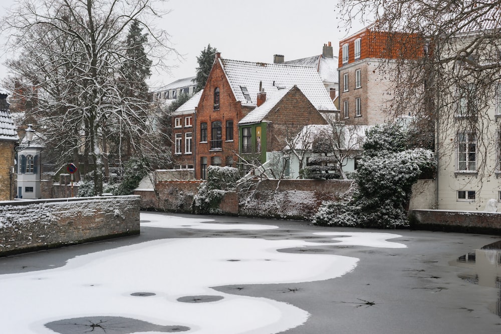 a snow covered street with buildings and trees