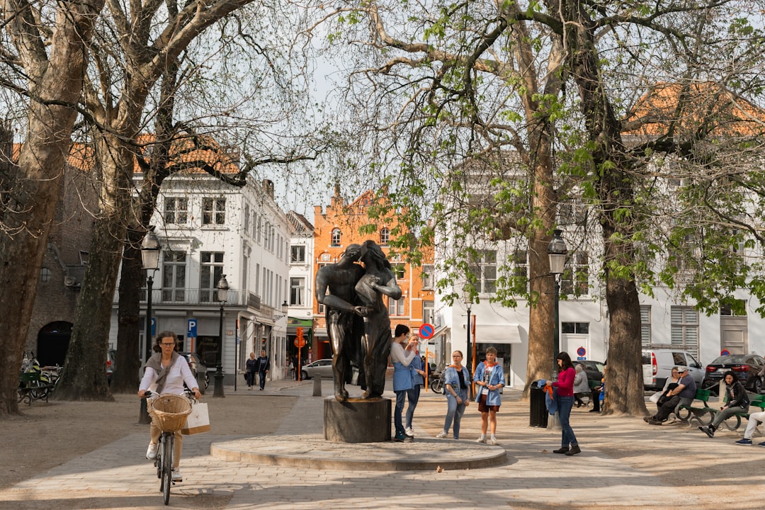 a group of people standing around a statue,