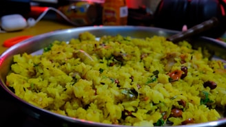 A vibrant bowl of ready-to-eat poha garnished with fresh coriander and lemon wedges, showcasing the freshness of our food range.