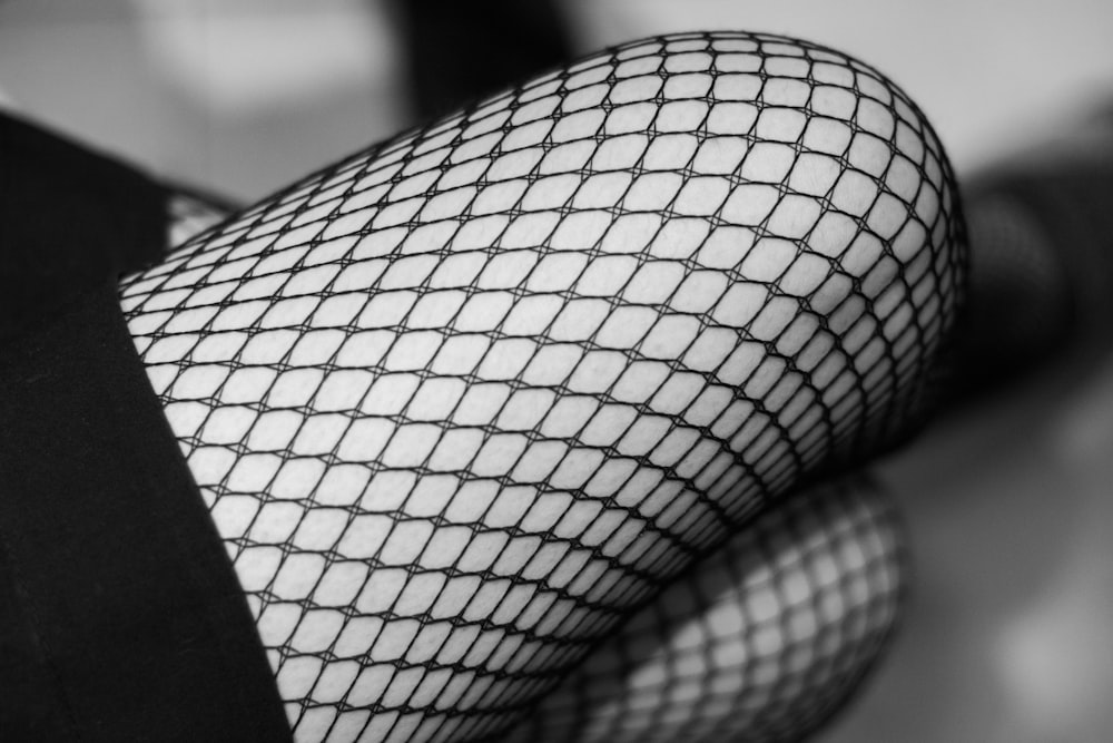 a close up of a person wearing fishnet stockings