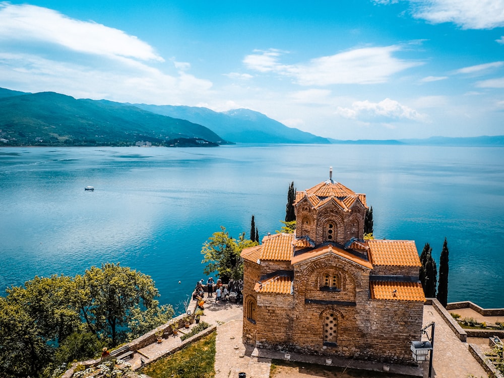 a church on a hill overlooking a body of water