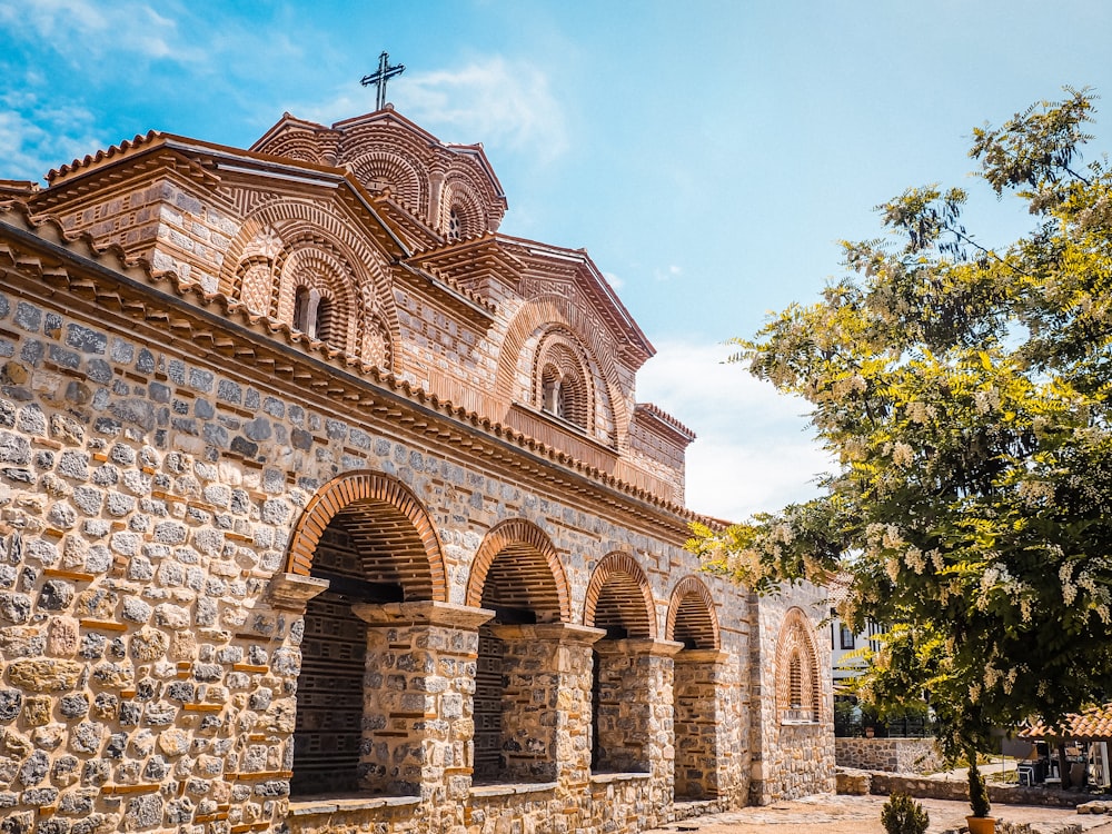 a stone building with a cross on top of it