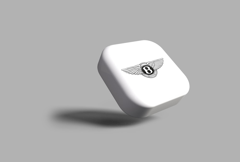 a white dice with a black and white logo on it
