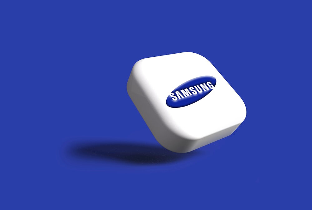 a white samsung logo on a blue background