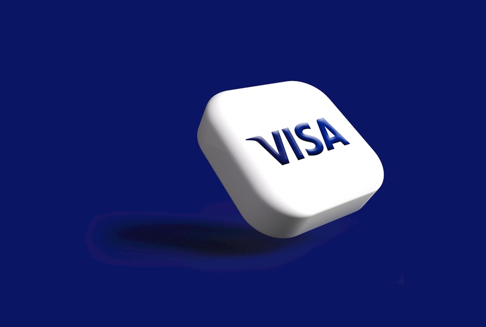 a white dice with the word visa on it