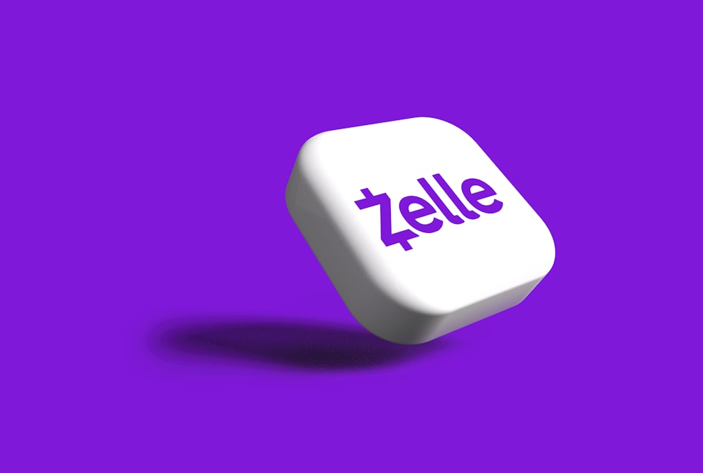 a white dice with the word zelle on it