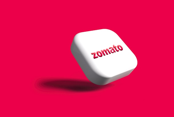 a white button with the word zomato on it