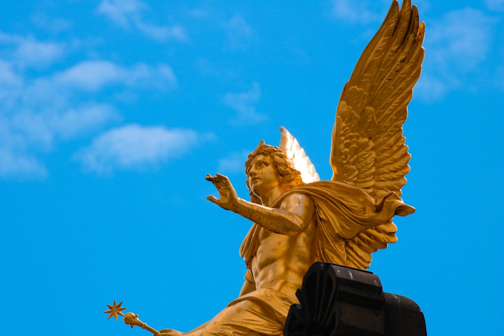 a statue of an angel on top of a building