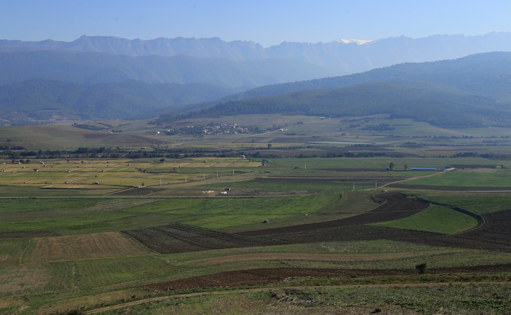 a view of a valley with mountains in the background