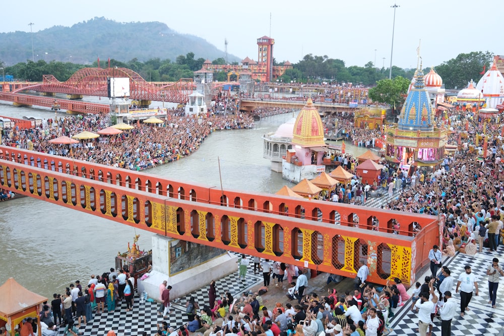 a crowd of people standing on top of a bridge