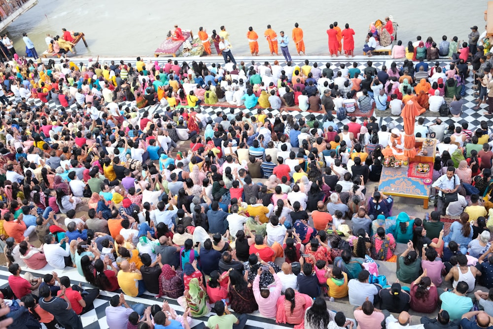 a large group of people sitting in front of a stage