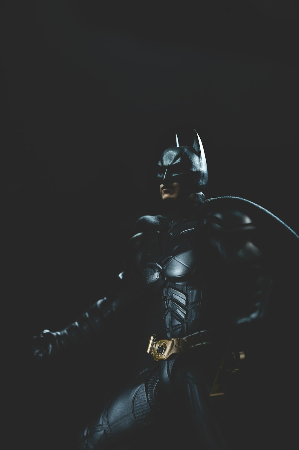 a man in a batman costume holding a bat