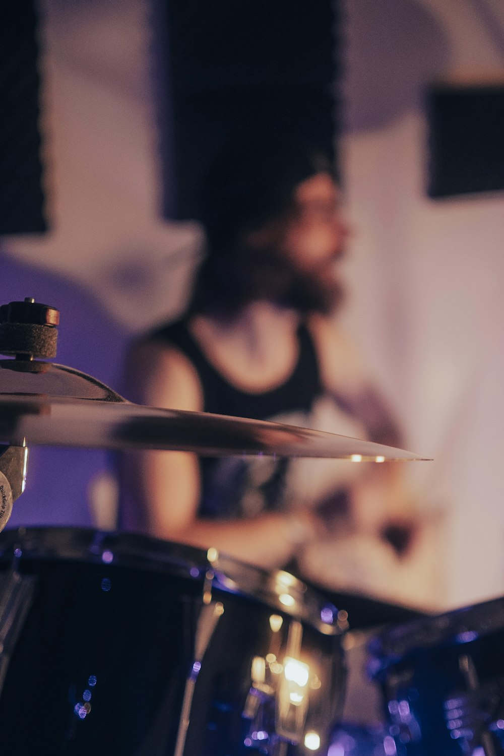 a man playing drums in front of a microphone