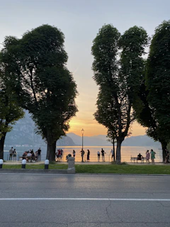 A peaceful moment of meditation by a lakeside at sunset with club members.