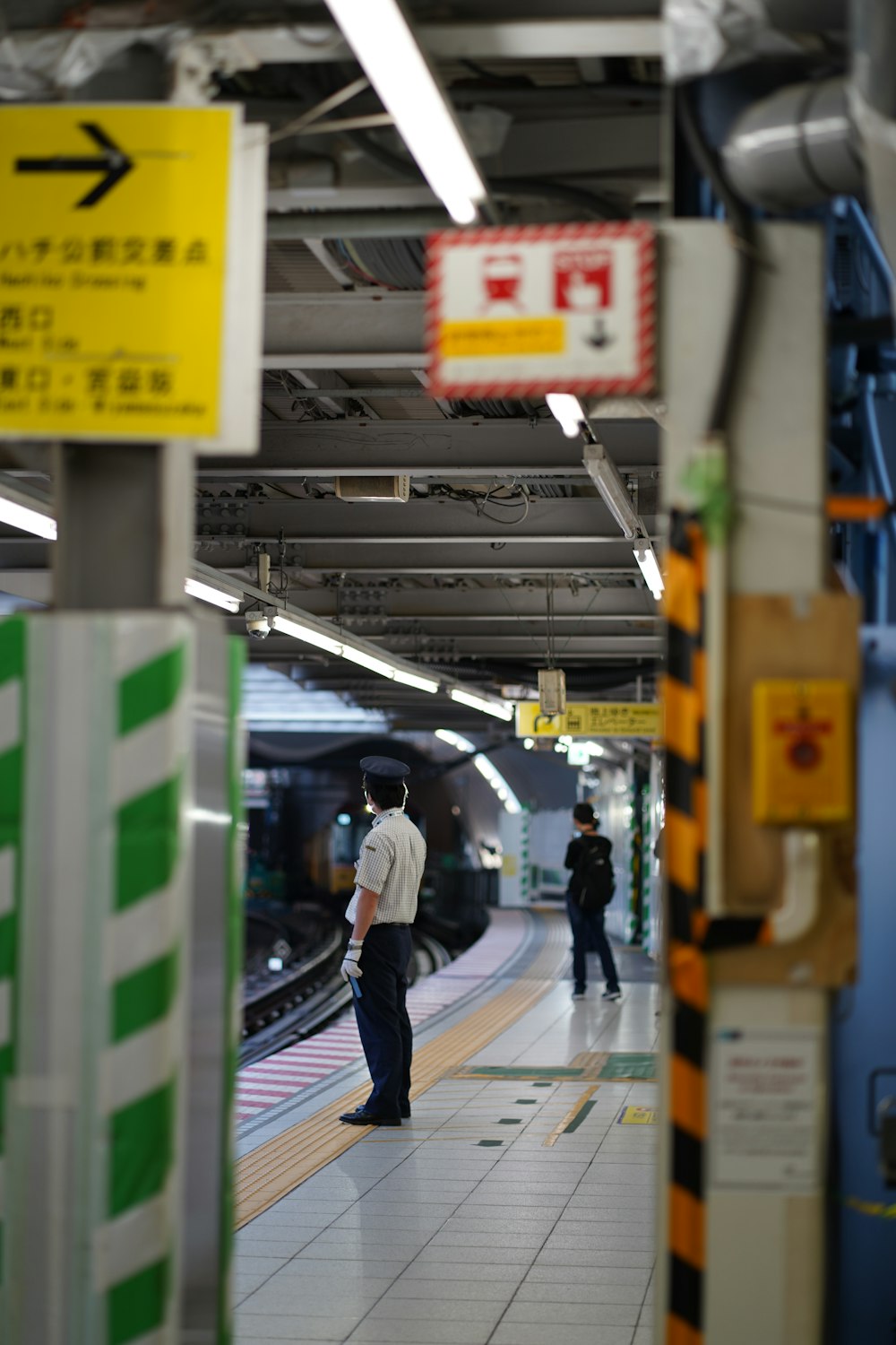 a man standing on a train platform next to a train
