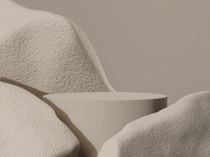 Artistic asymmetrical composition featuring layered materials in muted mineral tones.