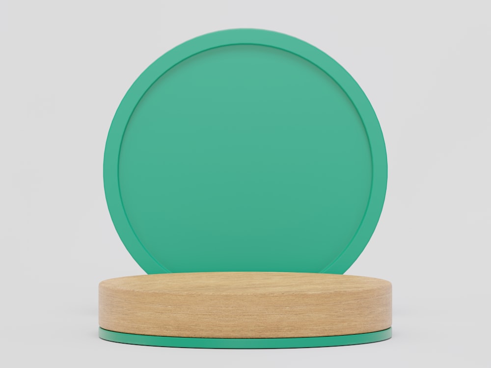 a green plate on a wooden stand on a white background