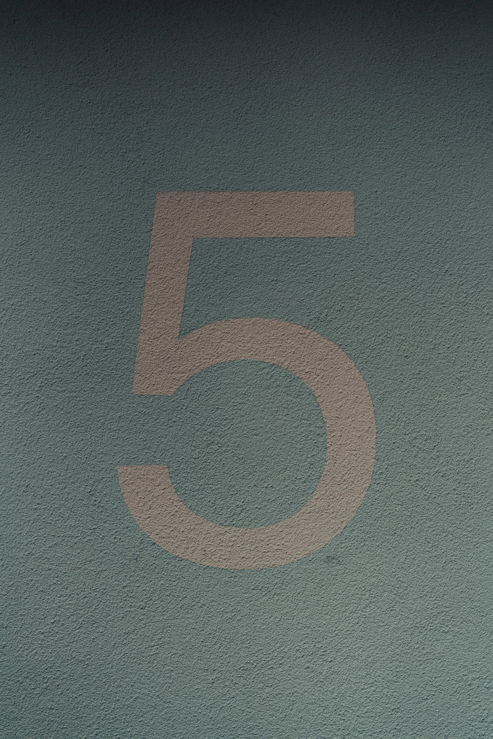 a close up of a number five on a wall