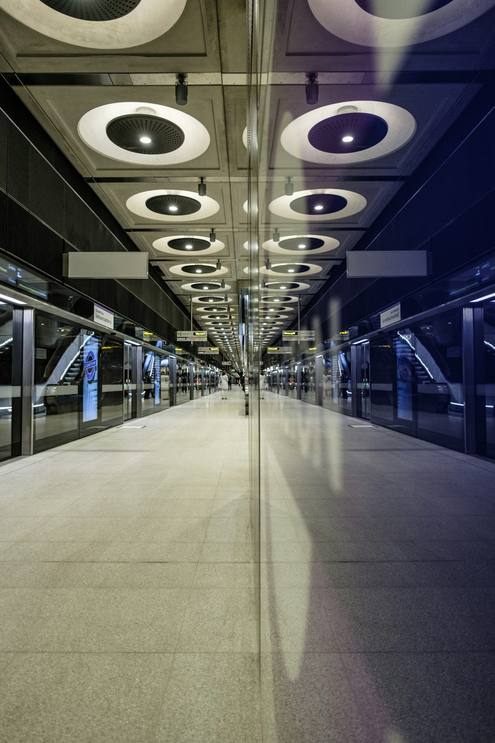 a long hallway with a lot of lights on the ceiling