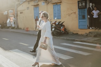 a man and a woman walking across a street