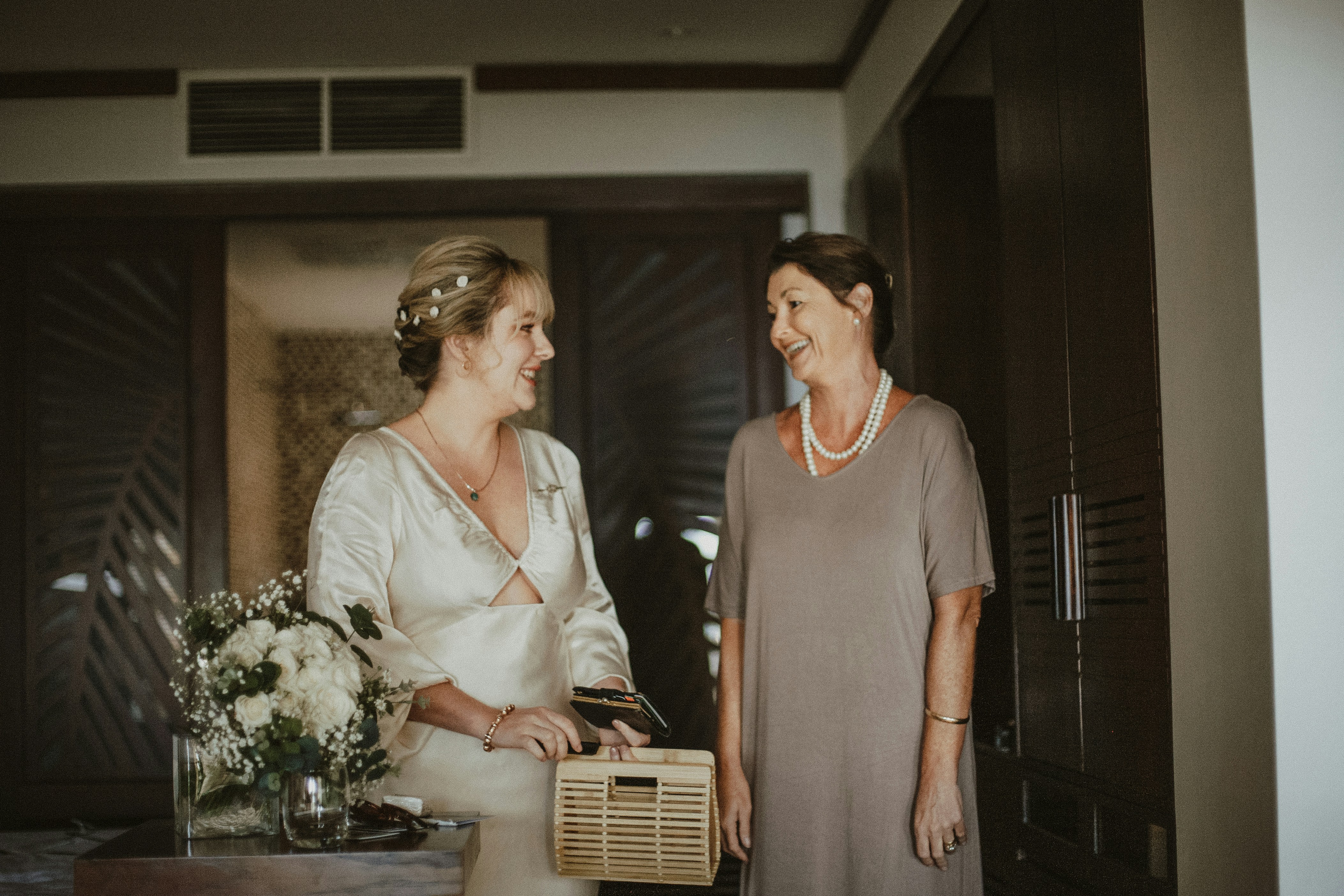 Two people meeting for the first time at a social event, smiling and engaged in conversation, casual bright setting