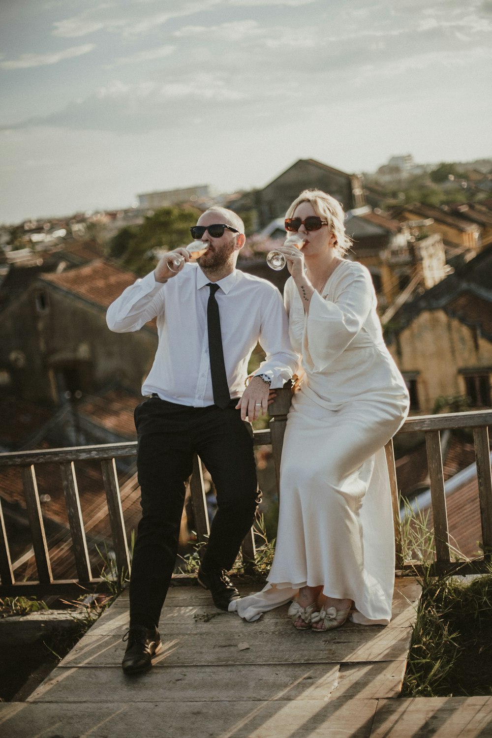 a man and a woman standing on a bridge