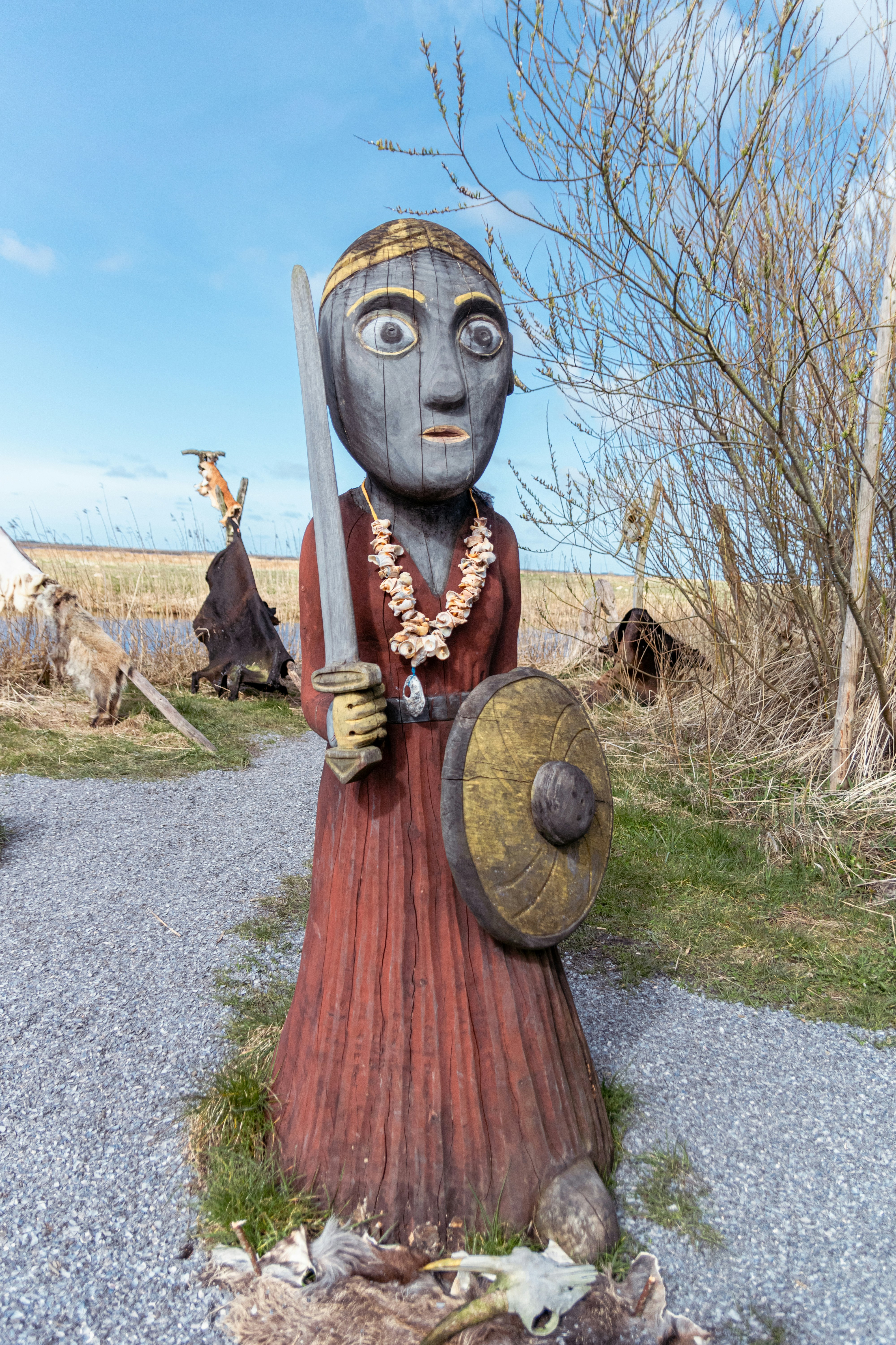 a statue of a woman holding a sword and shield