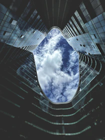 a very tall building with some clouds in the sky