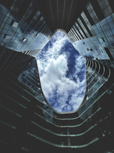 a very tall building with some clouds in the sky