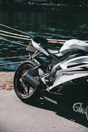 a motorcycle parked next to a body of water