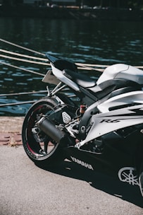 a motorcycle parked next to a body of water