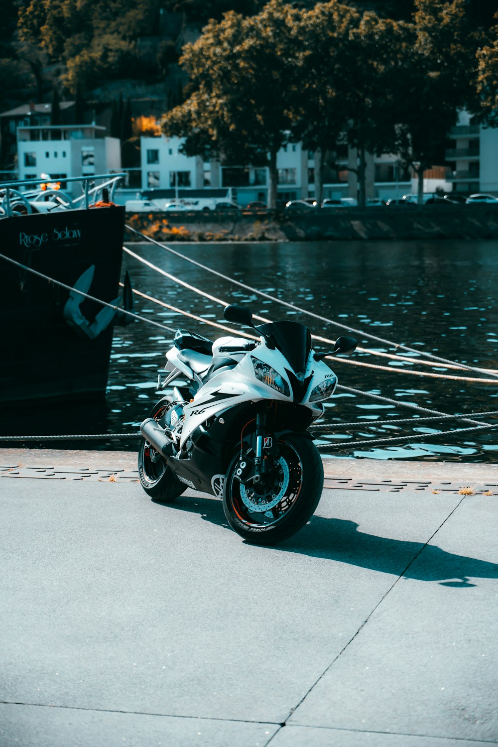 a motorcycle parked next to a body of water