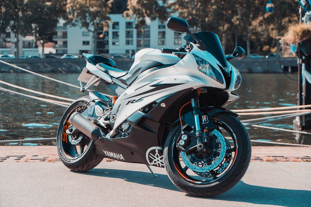 a motorcycle parked next to a body of water