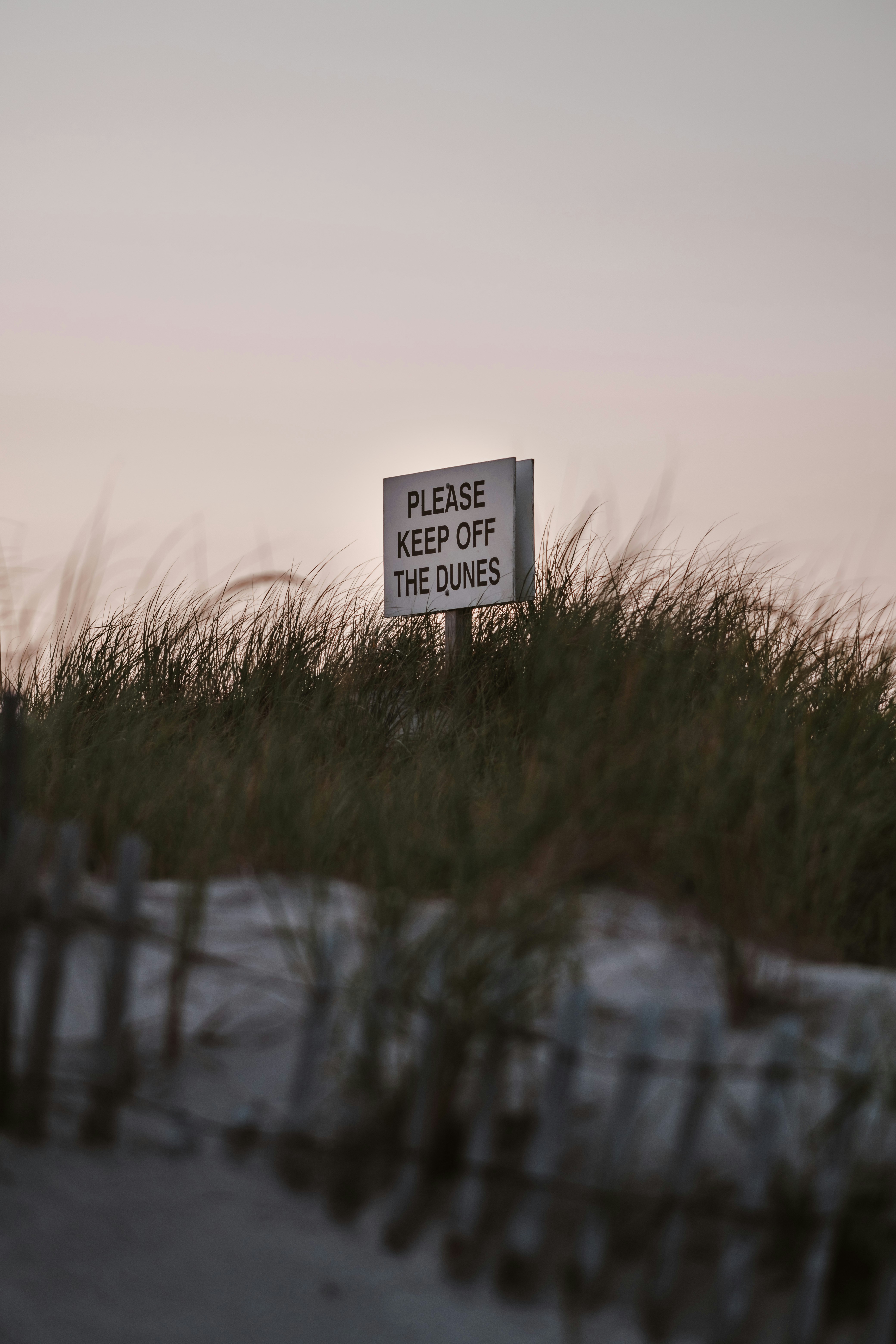 a sign that reads please keep off the dunes