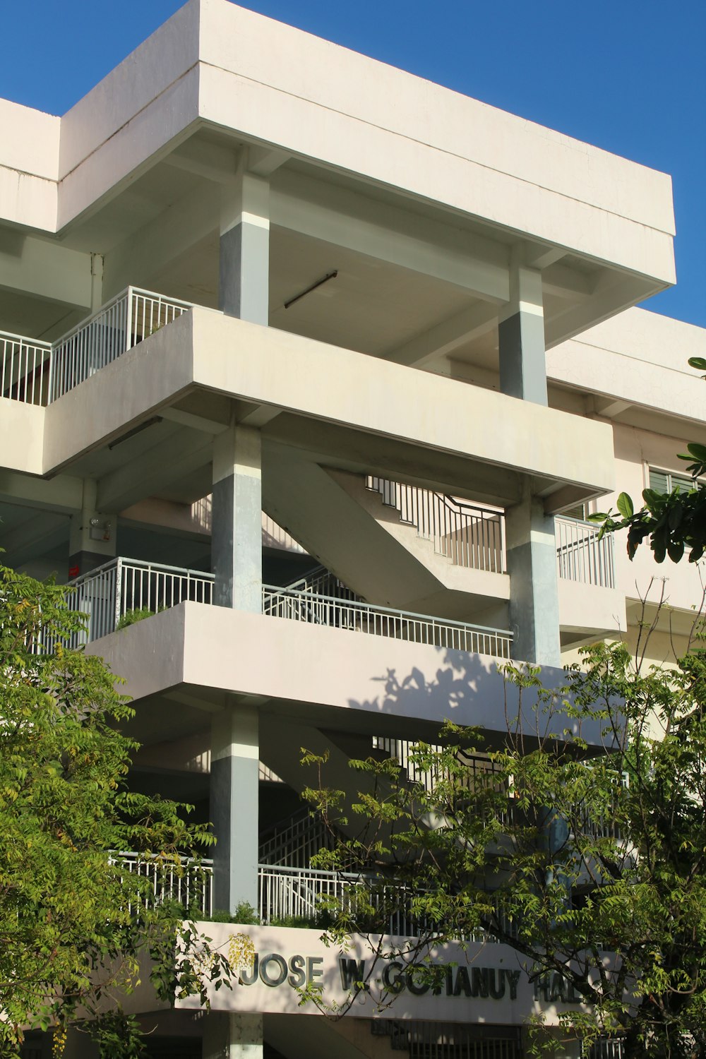 a tall white building with balconies and balconies