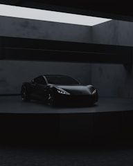 a black sports car in a dark room