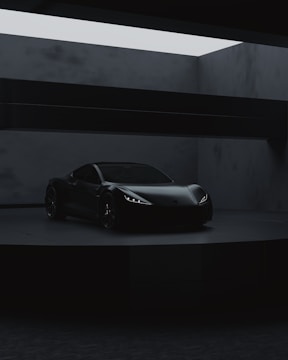 a black sports car in a dark room