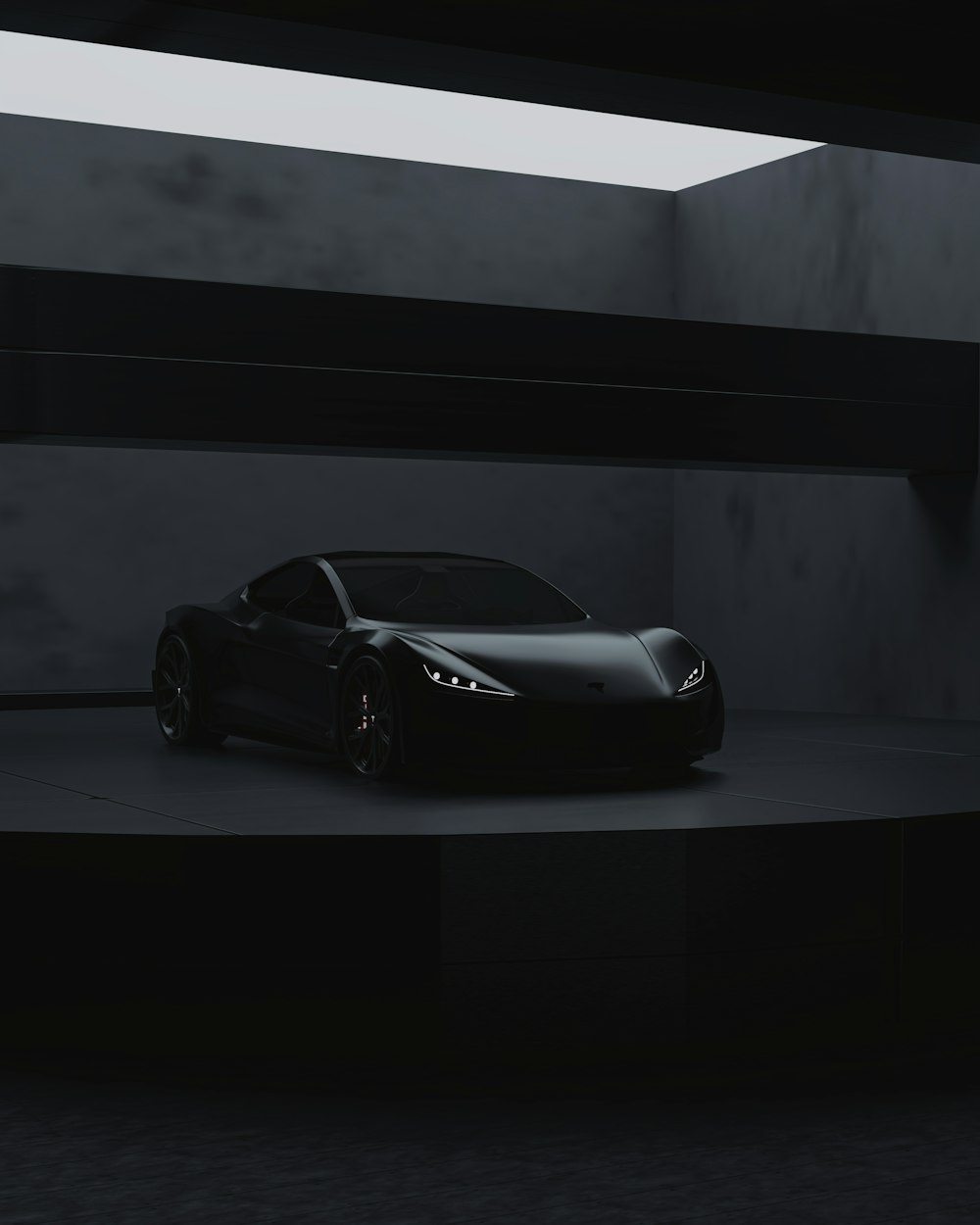 a black sports car in a dark room