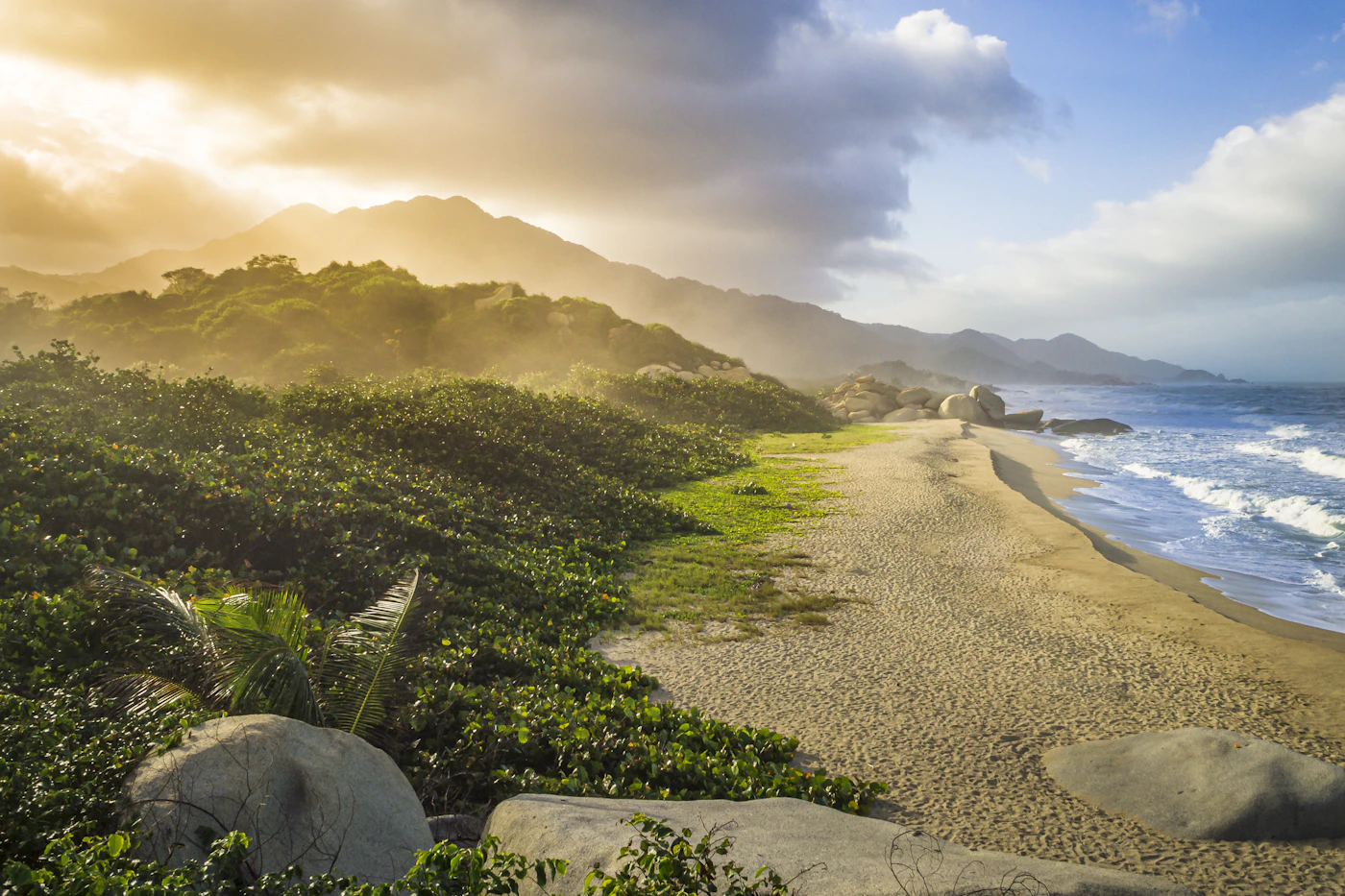 A Tayrona beach in golden light with the Sierra Nevada behind
