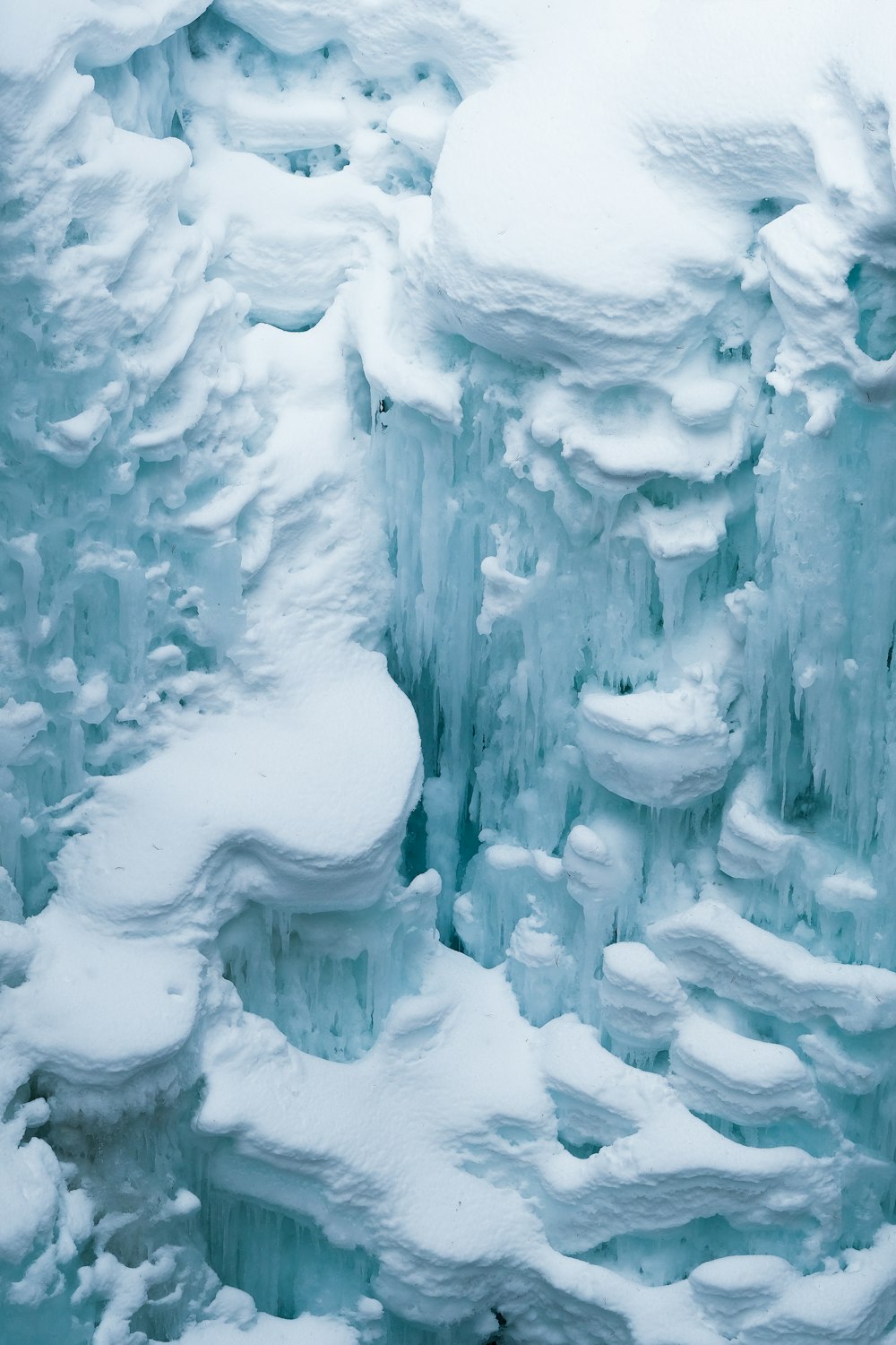 a very large ice cave with lots of snow on it