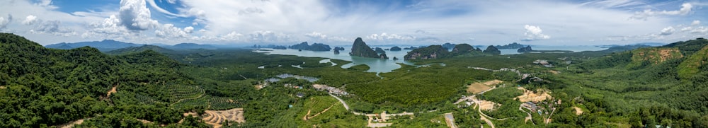 an aerial view of a mountain range with a body of water in the distance