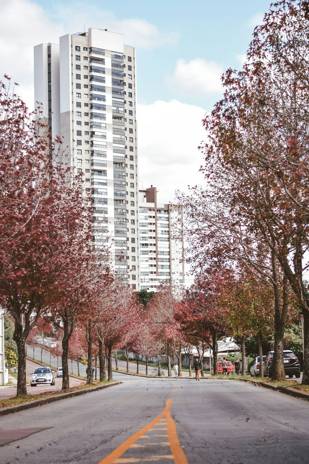 a street lined with tall buildings and trees