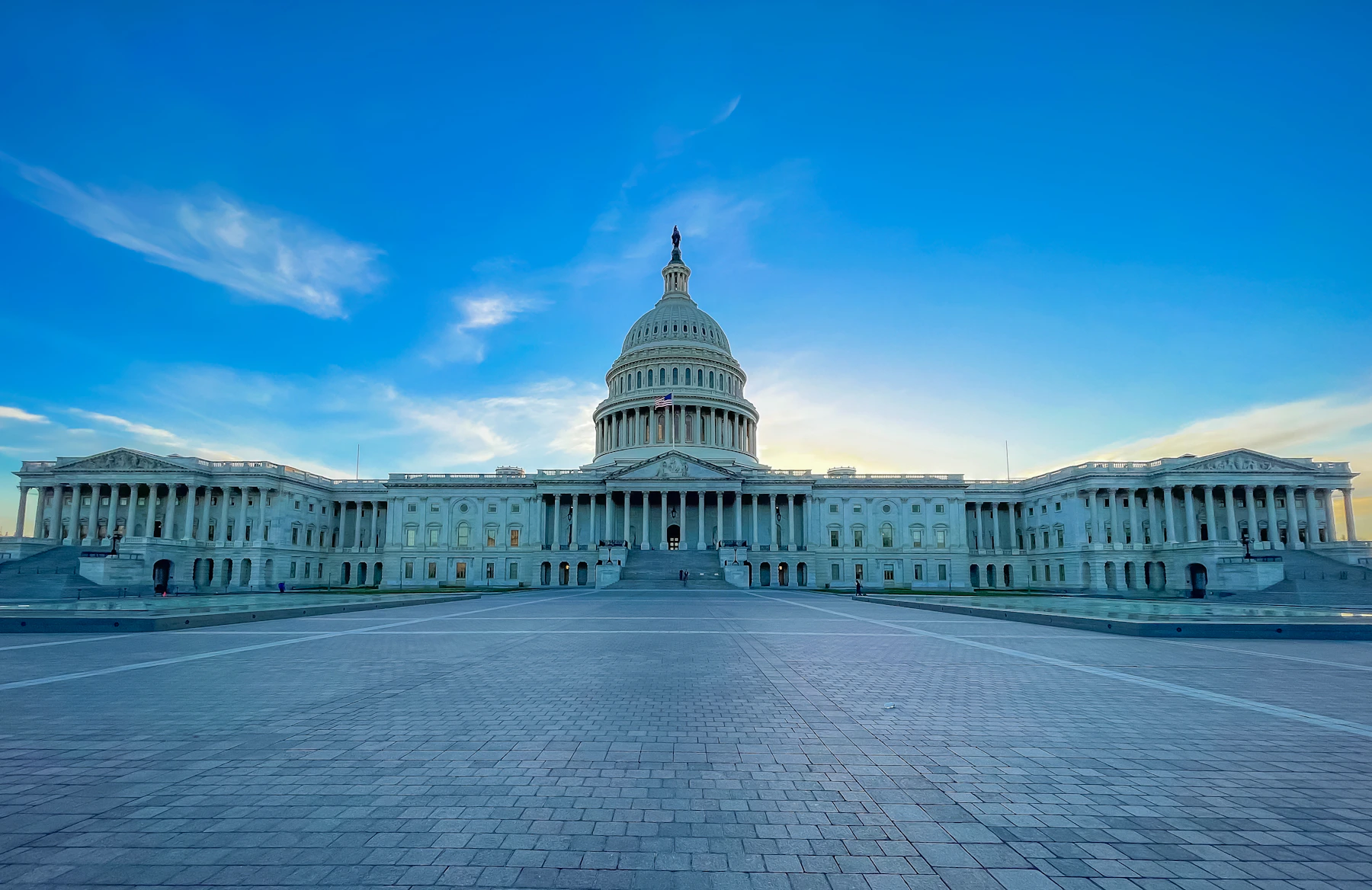 The United States Capitol building and its central dome in Washington DC beneath a blue sky