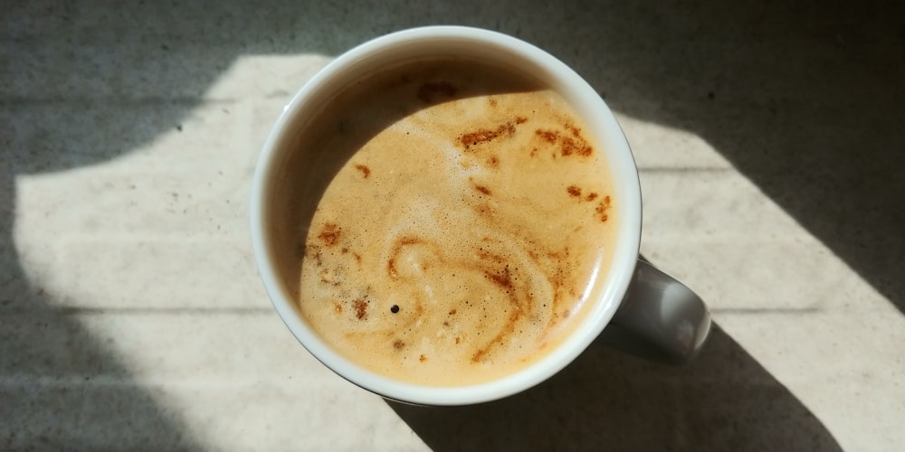 a cup of coffee sitting on top of a table