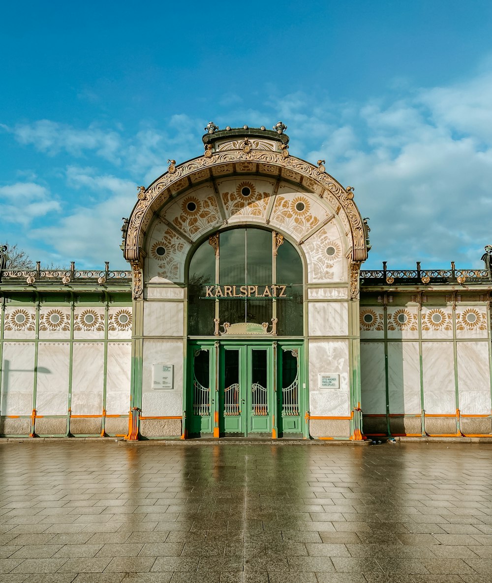 a green and white building with a green door