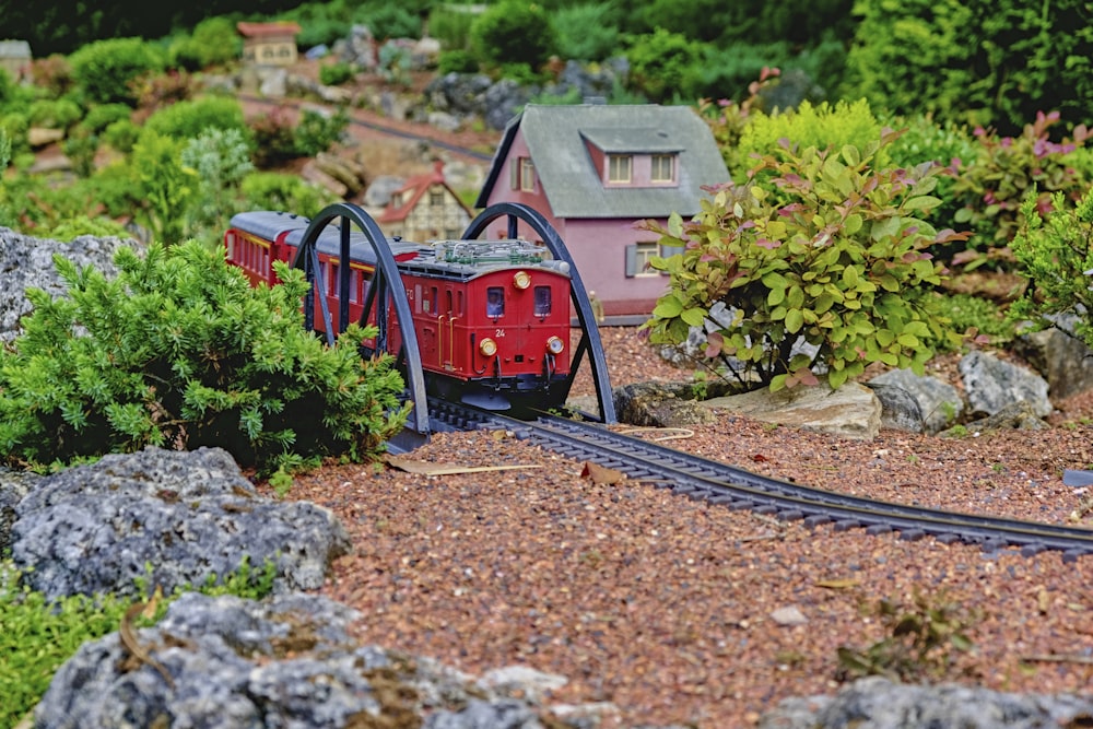 a model train set with a red caboose