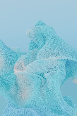 a blue and white sculpture with a sky background