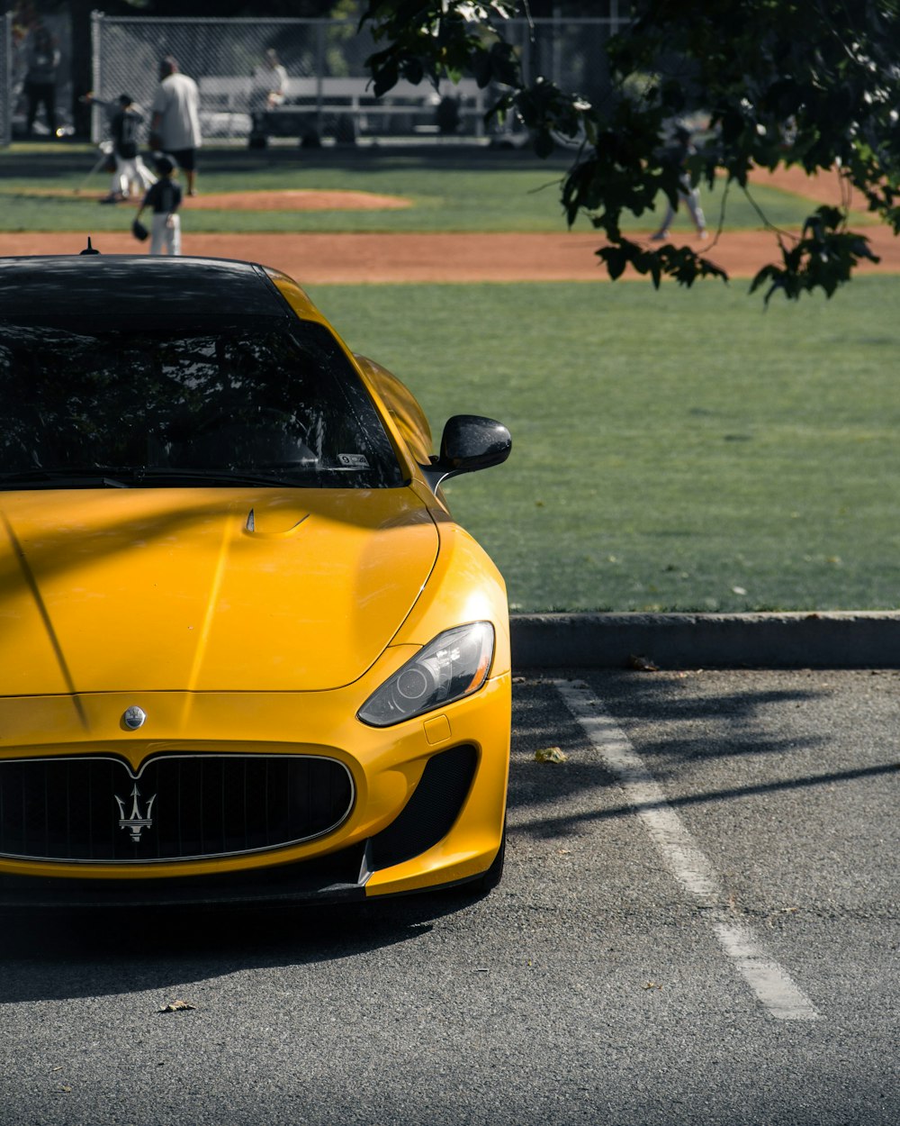 a yellow sports car parked in a parking lot