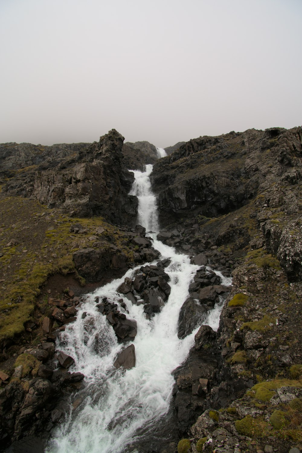 a stream of water running through a rocky area